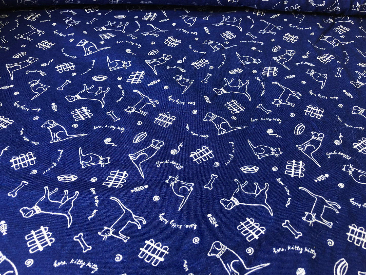 Royal blue knit with dogs and cats print 55" wide 2 3/4 yards